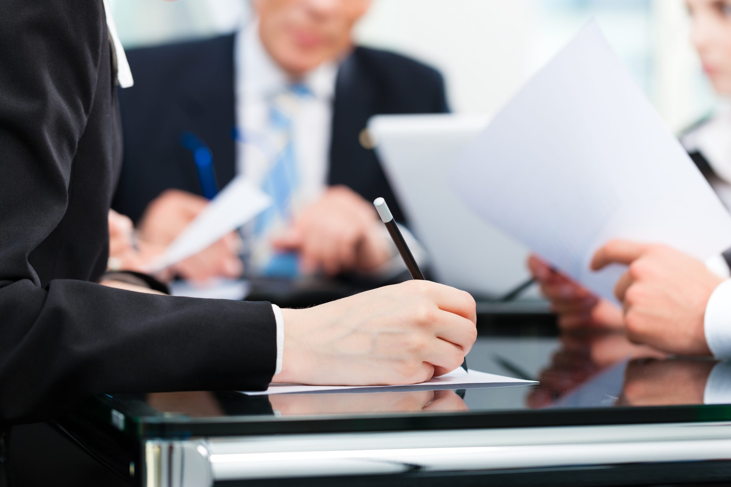 Business meeting with work on contract Business - meeting in an office, lawyers or attorneys discussing a document or contract agreement